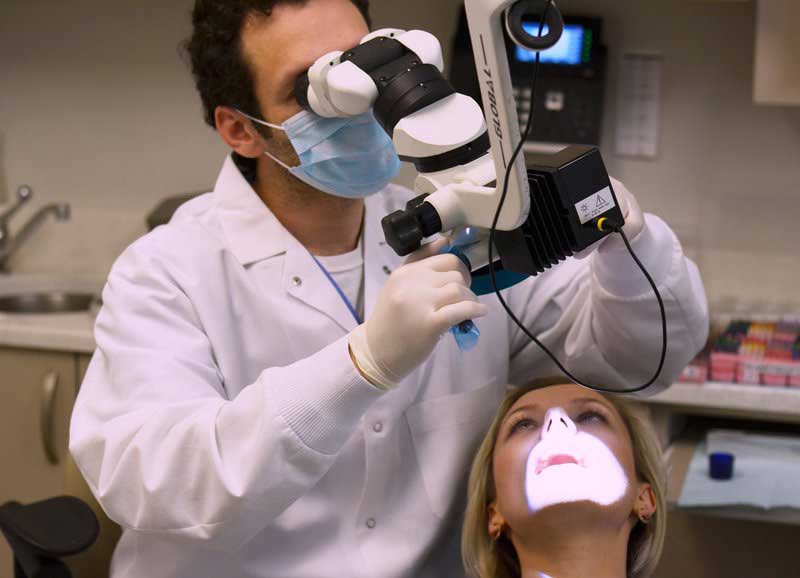 NYC Endodontist Dr. Steven Lipner uses microscope during endo treatment