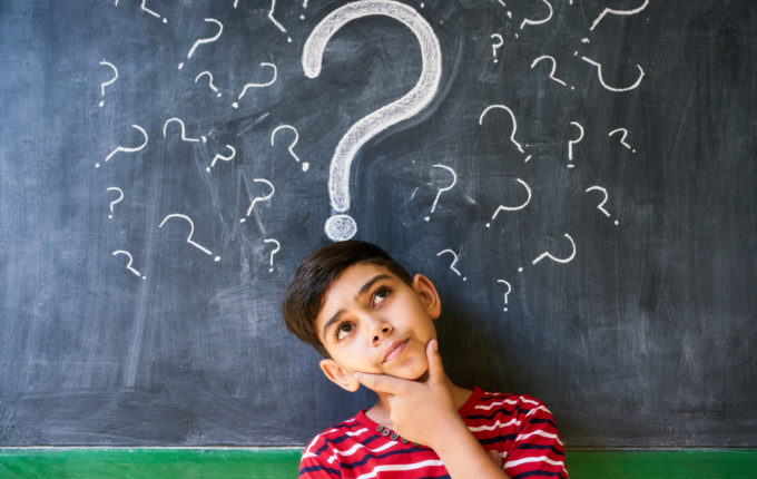 Doubts And Question Marks With Child Thinking At School